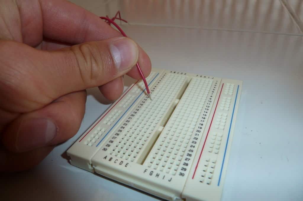 Pushing a wire into hole on a breadboard